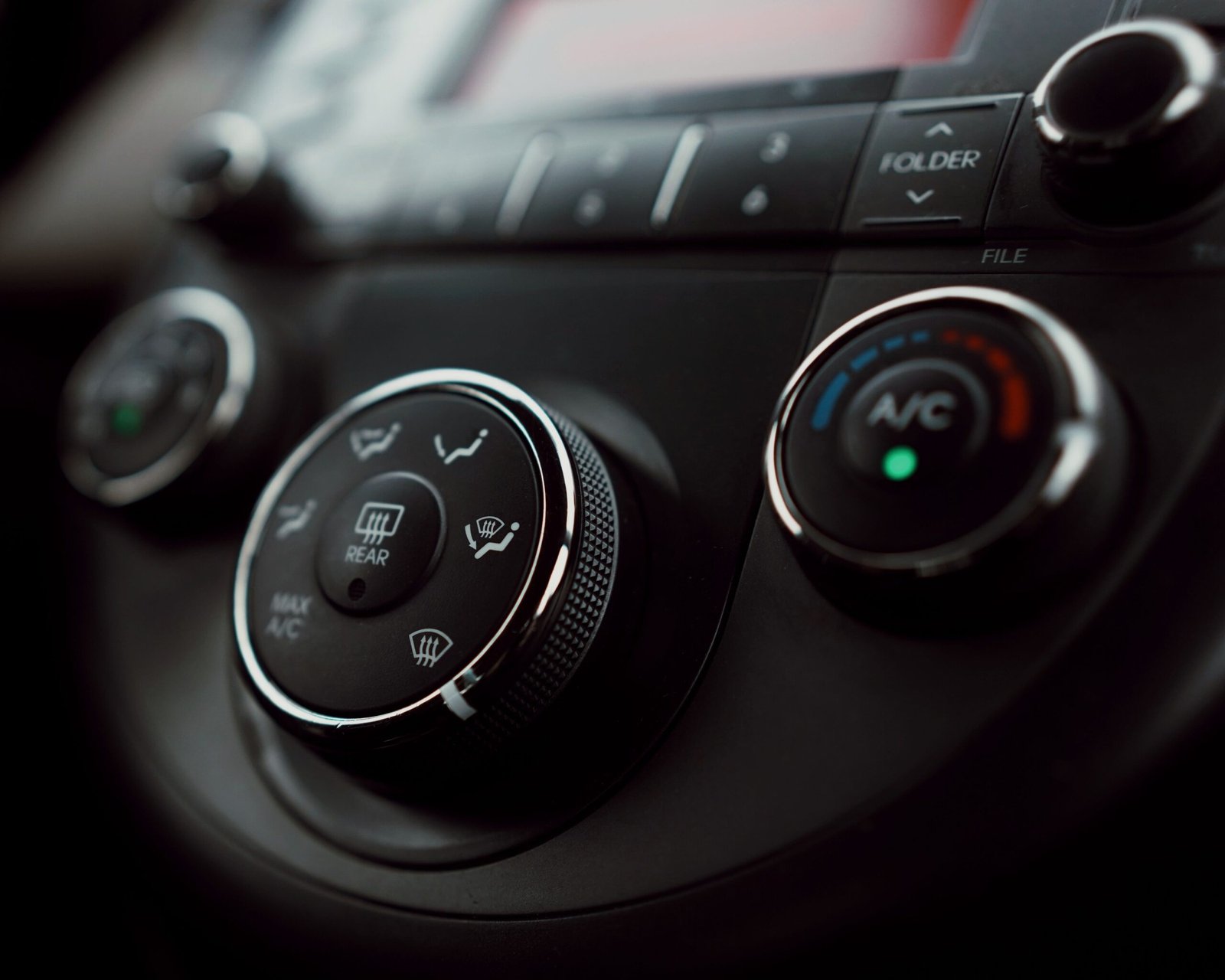Mechanic checking a car air conditioning system and gauges in Fort Worth, TX