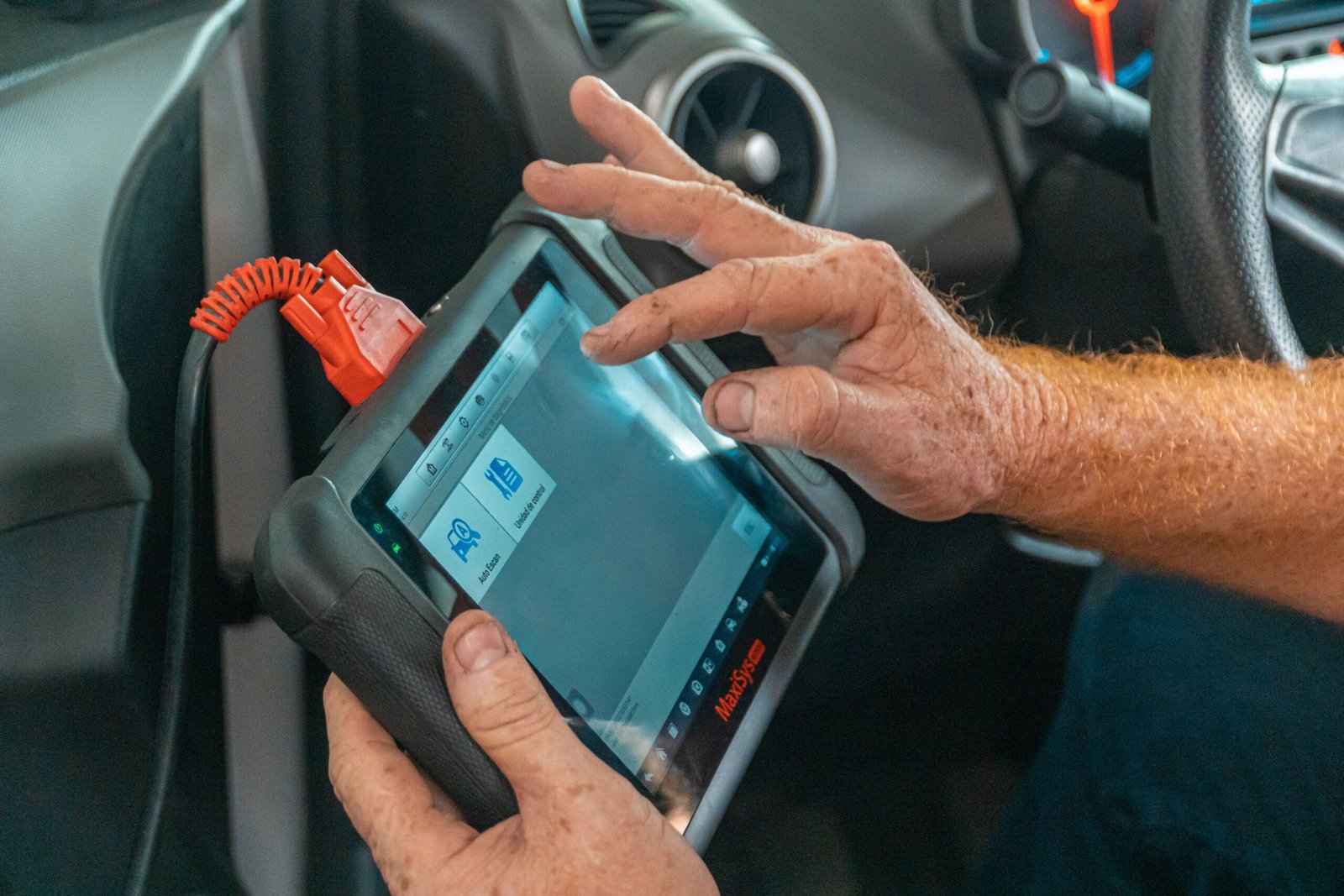 Technician using a diagnostic scanner on a vehicle's check engine light in Fort Worth, TX